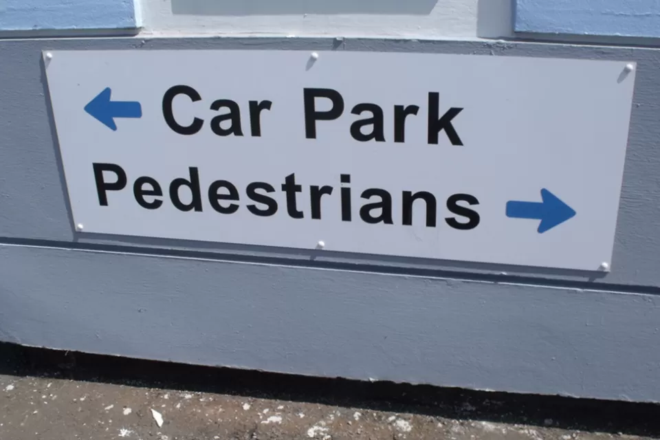 A sign for pedestrians and cars